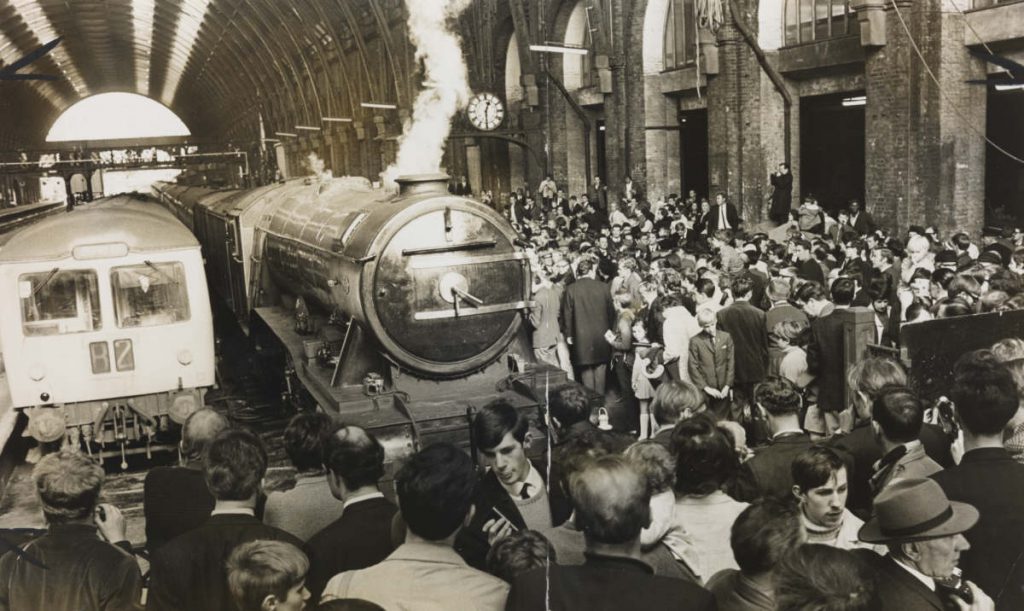 Black and white photograph of the Flying Scotsman steam train after restoration in London Kings Cross station in the 1960s