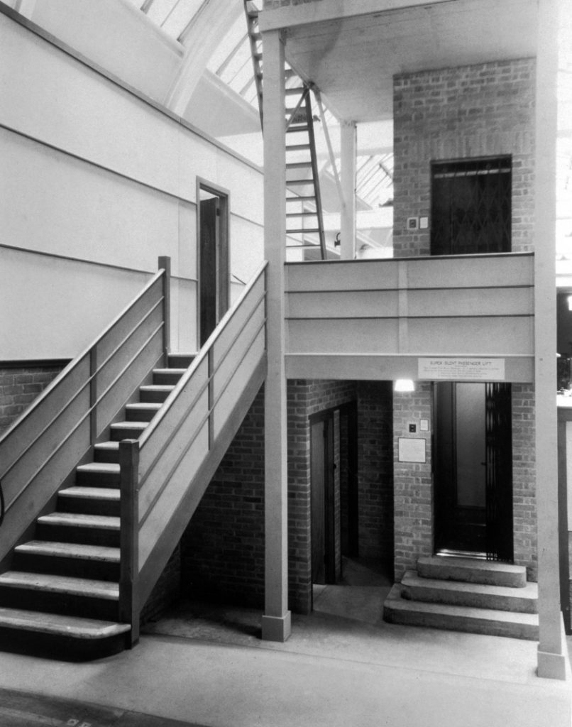 Black and white photograph showing a silent elevator installed at the Science Museum as part of the noise abatement exhibition