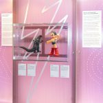 Colour photograph of Godzilla and Astro Boy models on display in a glass case