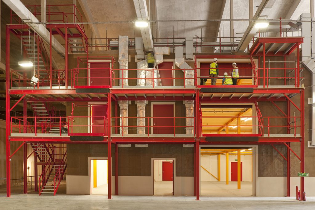 Colour photograph of a steel and hempcrete storage building under construction