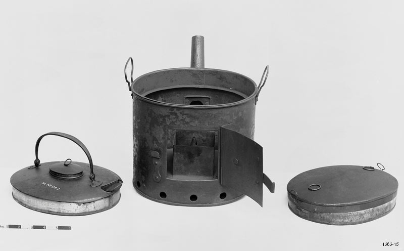 Black and white photograph of a metallic steam kettle