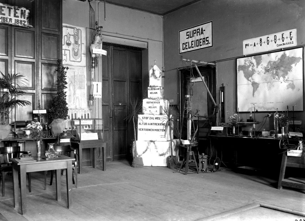 Black and white photograph of a small exhibition of scientific objects within a physics laboratory