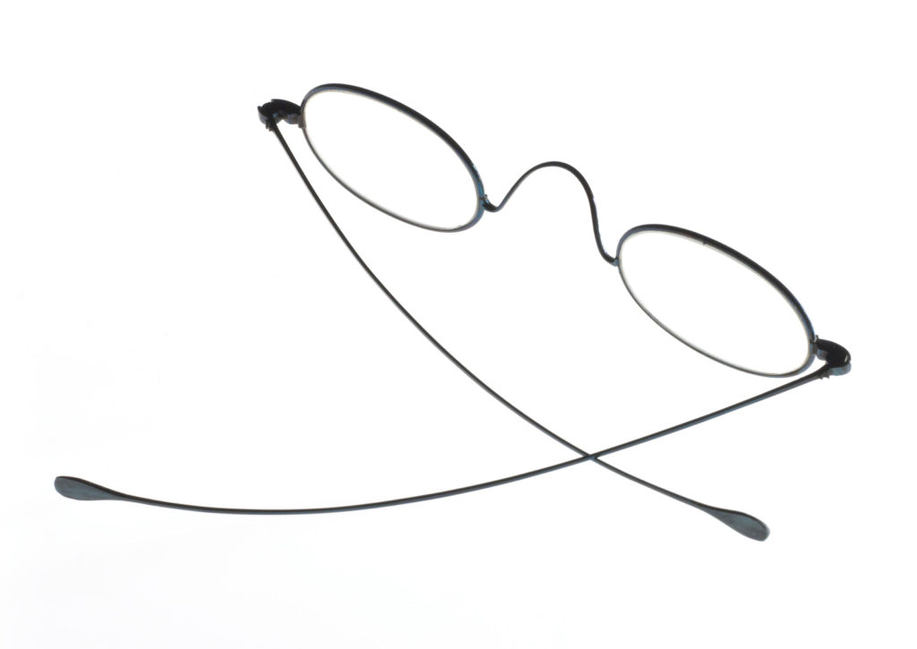 Colour photograph of a thin steel frame pair of spectacles