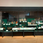 Colour photograph of historical cookery and dining items on display in an exhibition gallery