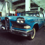 Colour photograph of a blue Ford Edsel car on display in a gallery