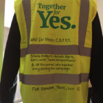 A yellow high vis vest printed with the words Together for Yes