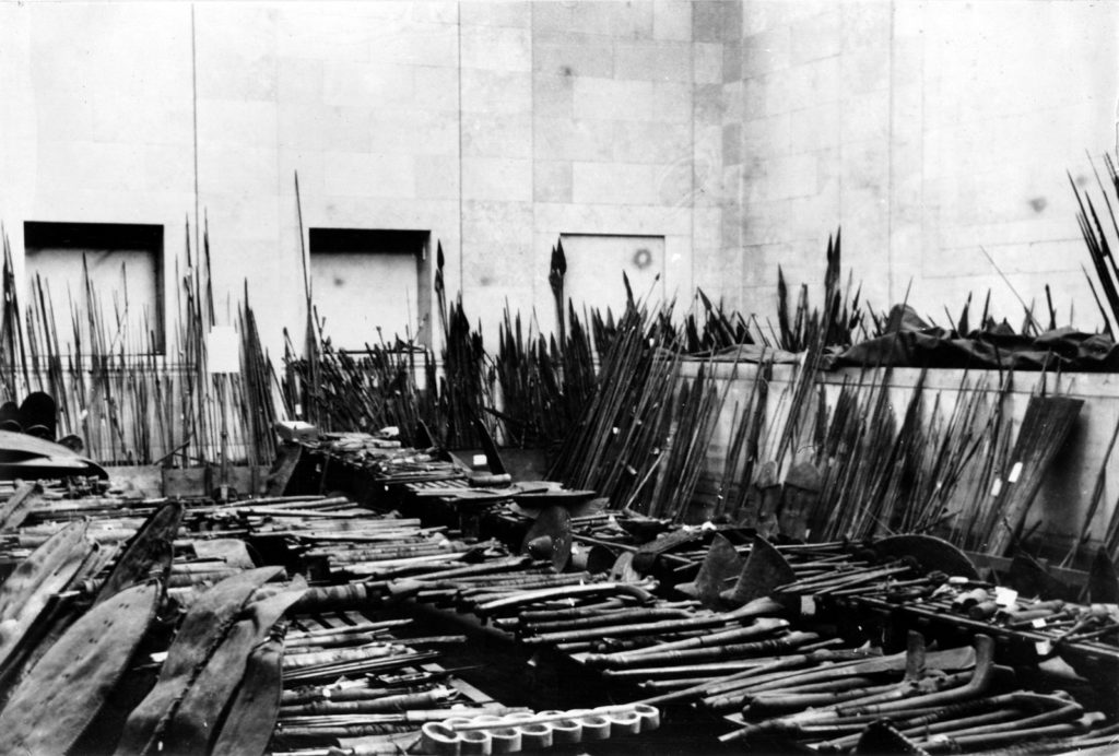 Black and white photograph of a cache of spears and swords