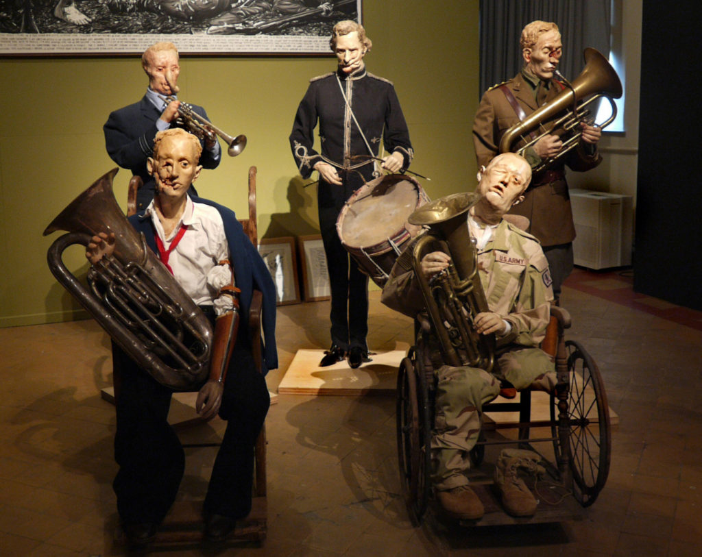 Colour photograph of a sculptured installation of wounded soldiers plaing musical instruments