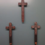 Colour photograph of cross grave markers on display