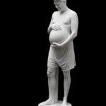 Colour photograph of a sculpture of a pregnant man