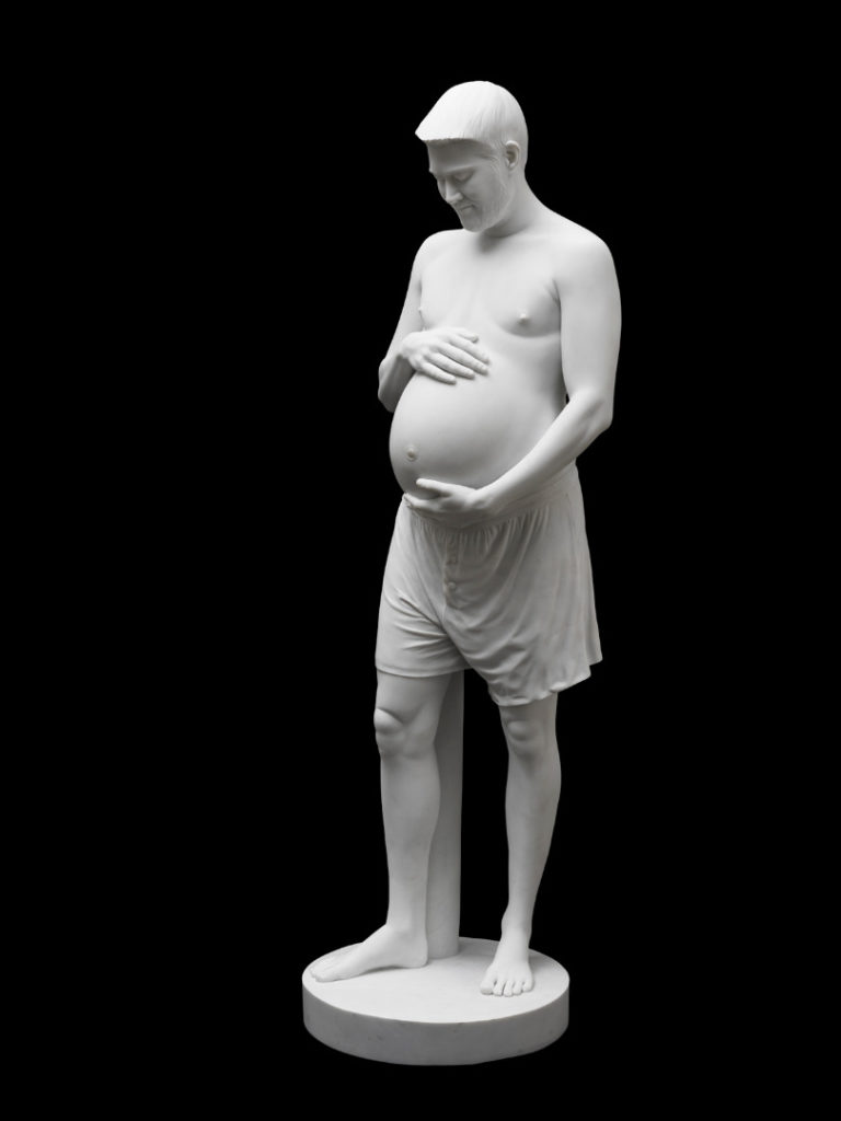 Colour photograph of a sculpture of a pregnant man