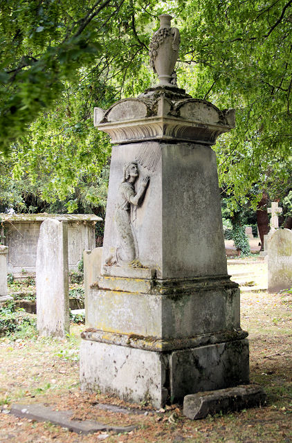 Colour photograph of an ornate tombstone for James Lowe