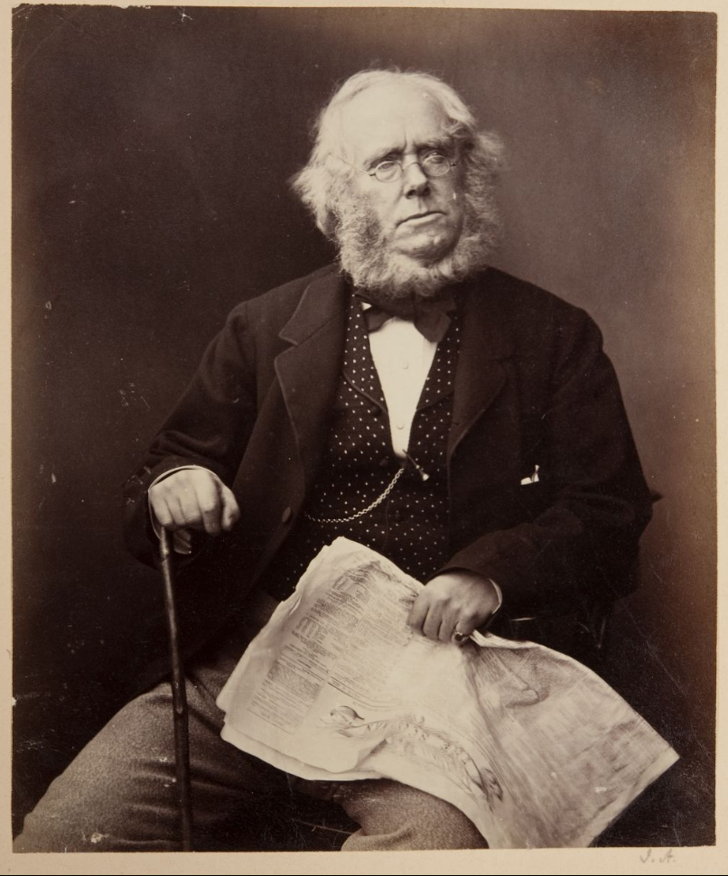 Sepia photograph of a seated James Playfair with newspaper and cane