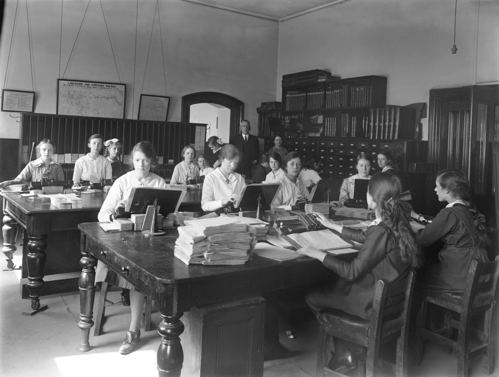 Black and white photograph showing female workers using Hollerith key punches