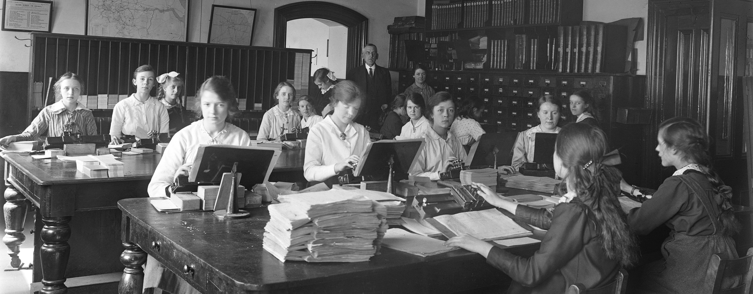 Black and white photograph showing female workers using Hollerith key punches