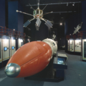 Colour photograph of the Black Arrow rocket displayed on the floor of a former Science Museum gallery