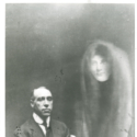 Black and white photograph of a seated man showing a spectral female figure beside him