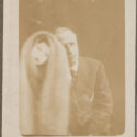 Sepia photograph of a seated man showing a spectral figure to his right