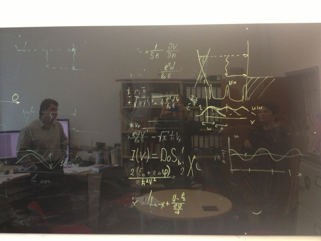 Kostya Novoselov with artist Cornelia Parker examining formulas calculated during graphene testing