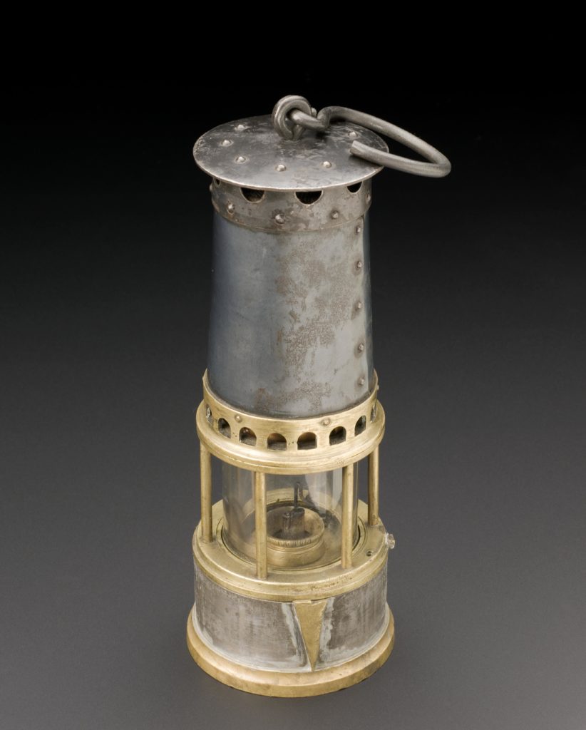 Colour photograph of a late nineteenth century miners safety lamp