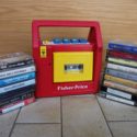 Colour photograph of a Fisher Price cassette player with cassette tapes