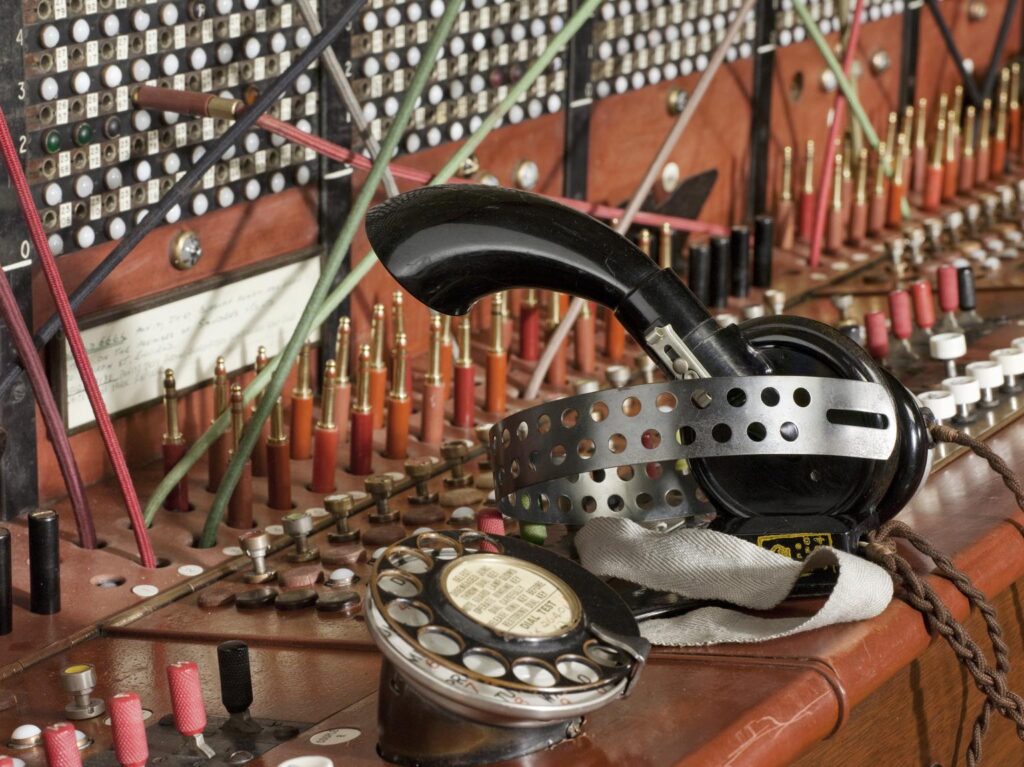 Colour photograph of a telephone switchboard with headphones