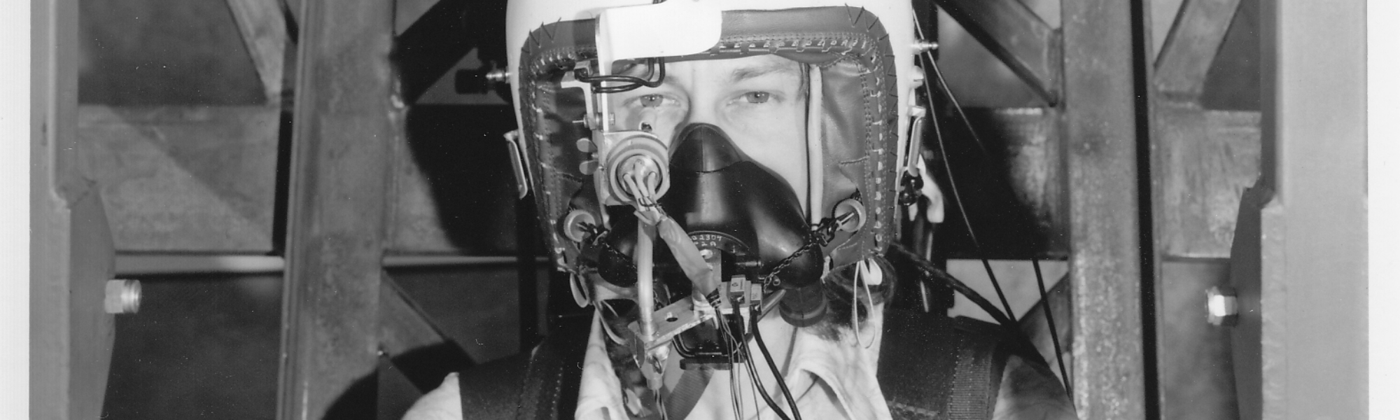 Black and white photograph of Phil Catling wearing equipment to test eye tracking ability under vibration in 1975