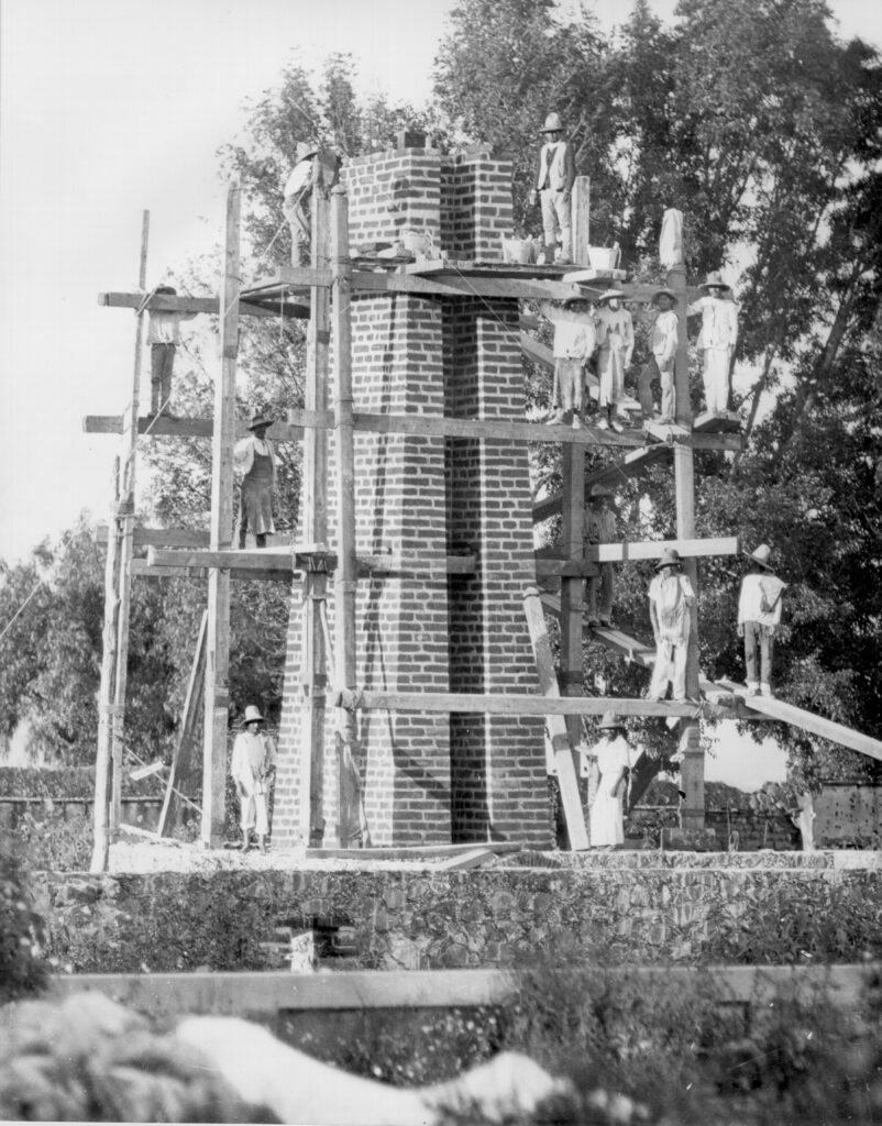 Monochrome photograph of a brick tower built to support a telescope