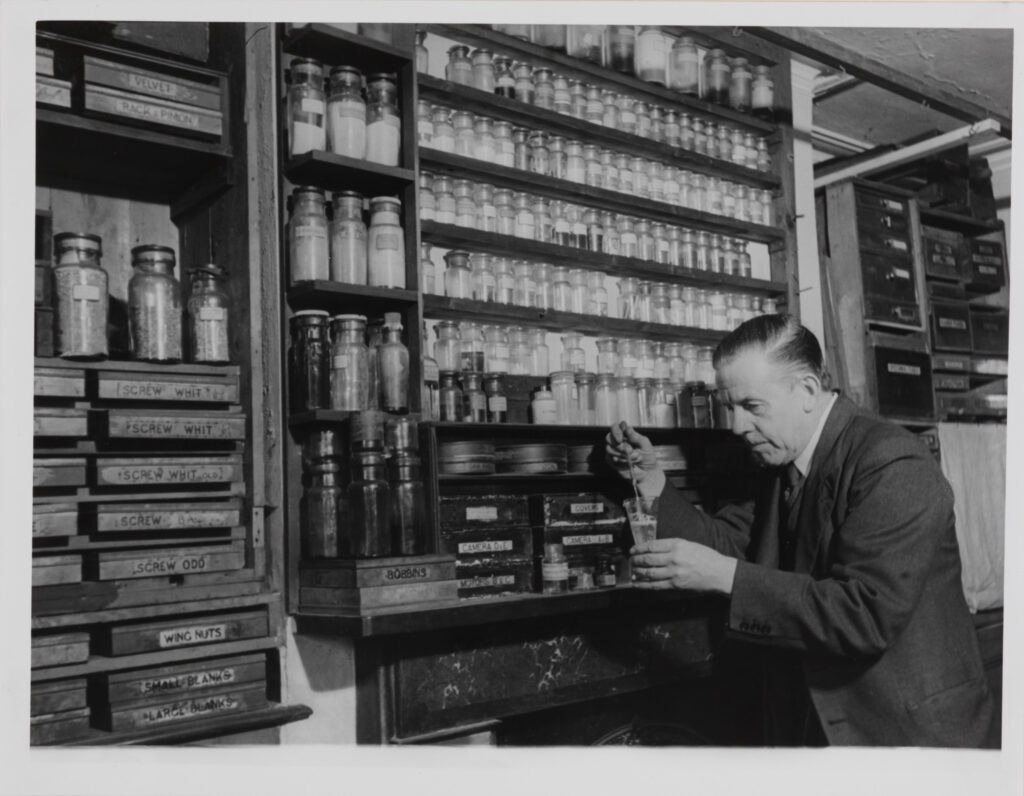 Monochrome photograph of Percy Smith working in his laboratory