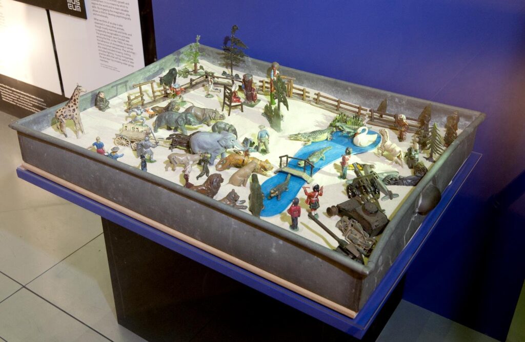 Zinc sand tray in which children would create imaginative worlds using sand and toys