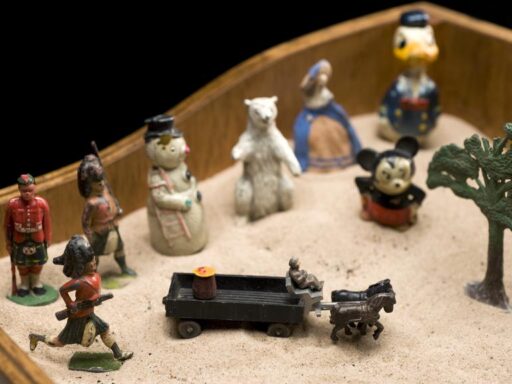 Colour photograph of childrens toys in a sandbox