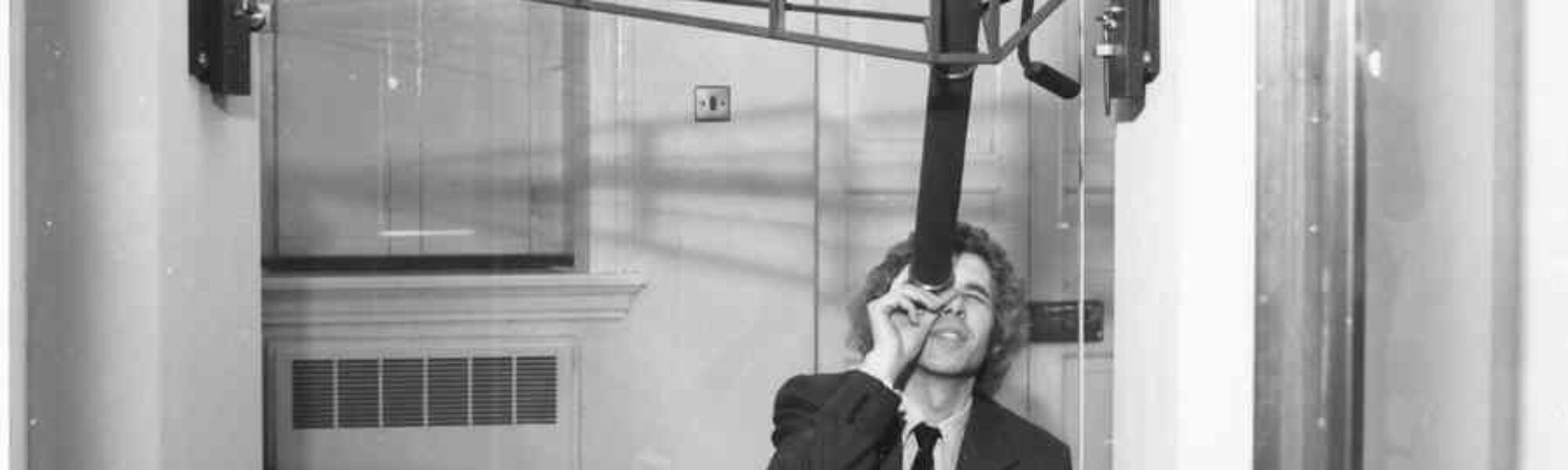 Black and white photograph of Jim Bennett with Halleys Transit Instrument circa 1977