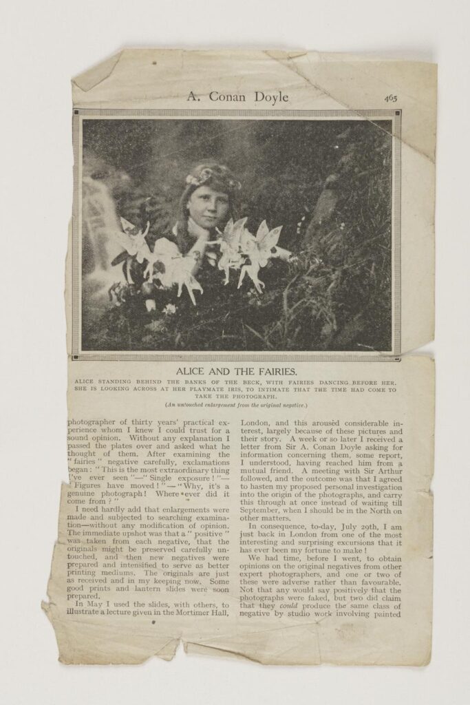 Magazine cutout against a white background, featuring a famous photograph of a young girl from the Cottingley fairies case