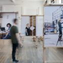 An exhibition at the Science Museum showing a display of photographs of people near road signs and at work.