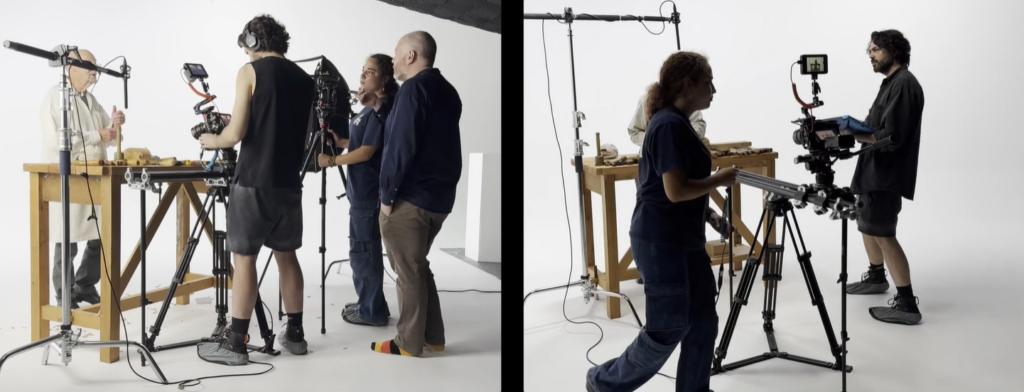 Men and women on a film set, moving equipment around and giving instructions to their actor.