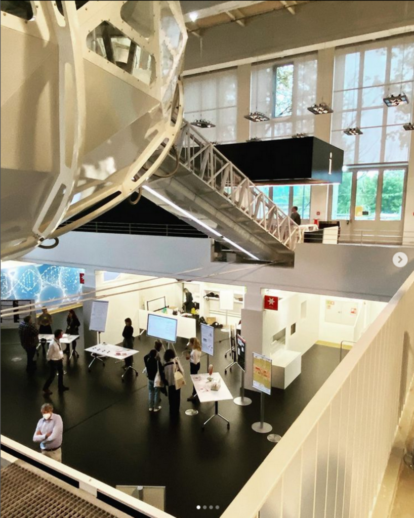 Image of the Science Communication Lab, with computers and various research equipment on lower floor and windows o upper floor.