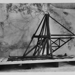 Black and white photograph of a large wooden model of a canal excavating machine