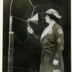 Black and white photograph of Dame Ellie Melba singing into an early microphone from 1920