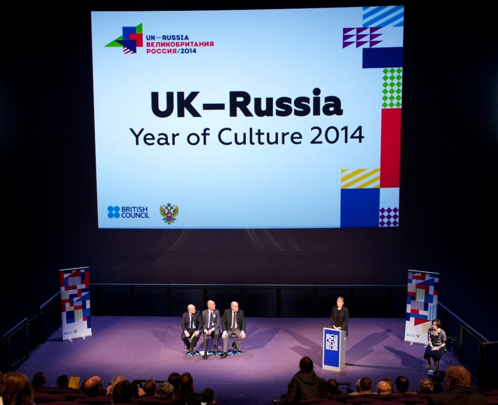 Colour photograph of the UK & Russia year of culture press conference showing a discussion panel and large projection