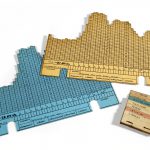 Colour photograph of two individual chart cards from a 1950s three dimensional chart showing electricity demand over time