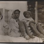 Black and white photograph of two adult females showing elephantiasis of the legs accompanied by a nun