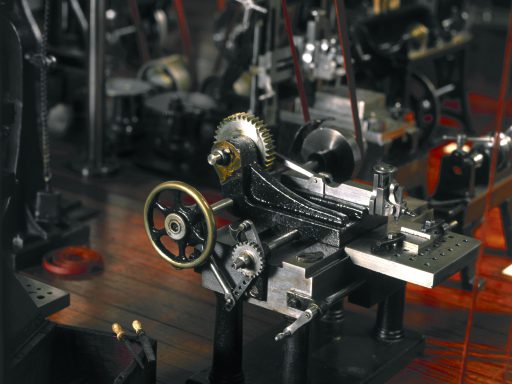 Colour photograph of detail of a miniature machine workshop model from late 1800s on display in the Science Museum London