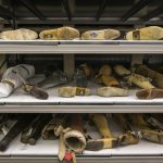 Colour photograph of prosthetic limbs in shelving storage