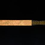 Colour photograph of of a letter opener with a an 1894 calender and world map