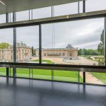 Colour photograph of a view of an old museum from the visitors pavilion of an adjacent museum