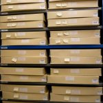 Colour photograph showing shelves of boxes containing photographs