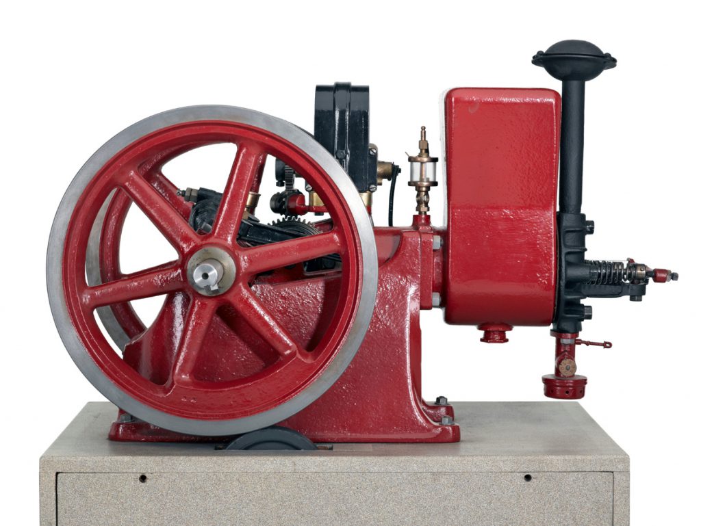 Colour photograph of a horizontal single cylinder petrol engine designed to power farm equipment and workshop tools