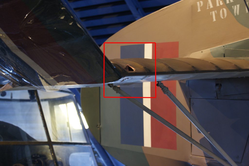 Colour photograph of a tear in the fabric covering the wing of a Cierva C30A aircraft