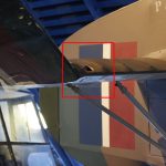 Colour photograph of a tear in the fabric covering the wing of a Cierva C30A aircraft