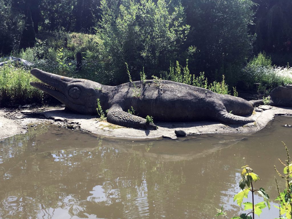 Colour photograph of a concrete icthyosaur model situated outdoors